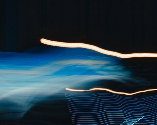 Stylized graphic showing fluid lines of movement and harmony.