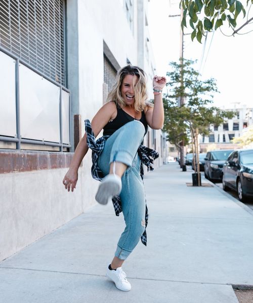 Woman feeling energetic and full of life in a bright setting.